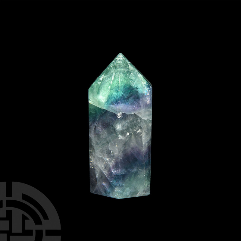 Large Fluorite Obelisk. A cut and polished fluorite obelisk; held in a white car...