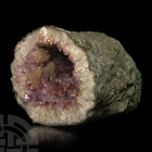 Large Amethyst Crystal Geode Display Specimen. A large display portion of an amethyst geode showing part of the exterior surface together with the int...