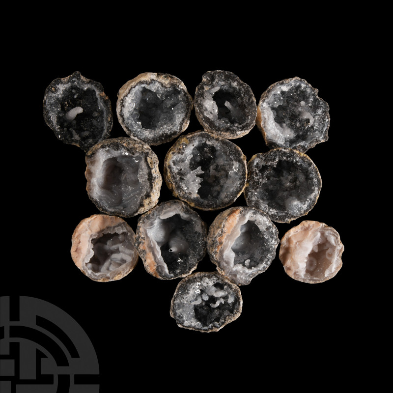 Quartz Crystal Geode Half Group. A group of twelve cut grey quartz geode halves,...