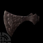 Viking Age Broad Axehead. 10th-11th century A.D. An iron axehead with broad flaring triangular-section blade extending to a curved edge, socket with l...
