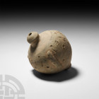 Byzantine 'Greek Fire' Fire Bomb or Grenade. 9th-11th century A.D. A piriform ceramic fire bomb with domed mouth and knop base, raised lugs to the cir...