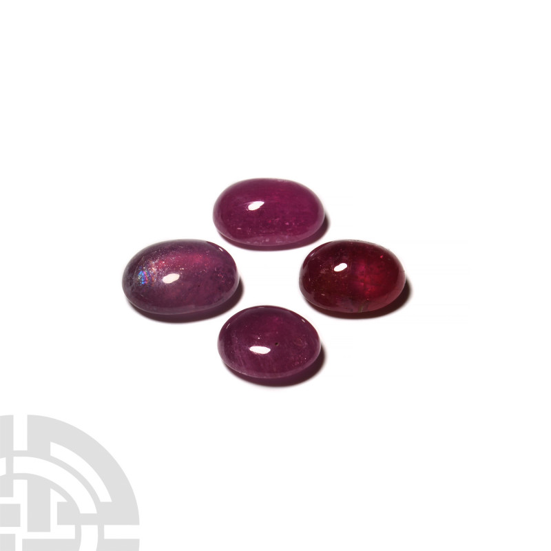 27.85 Carat Polished Ruby Cabochon Group. A group of four polished ruby cabochon...