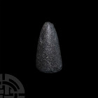 Stone Age Grinding Stone. Neolithic, 8th-3rd millennium B.C. A dark stone grinding stone with a sub-conical profile, rounded apex and one circular fac...