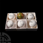 Cut and Polished Mineral Sphere Collection. A group of six polished mineral spheres comprising five howlite and one unakite; each held in a white card...