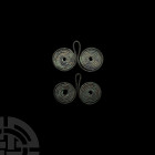 Bronze Age Coiled Spectacle Pendant Group. 16th-10th century B.C. A group of two spectacle pendants, each composed of two coiled wire circles joined b...