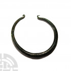 Bronze Age Decorated Torc. 12th-13th century B.C. A bronze penannular torc with decorative triangles and lines to the centre of the shank, hooked ends...