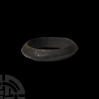 Bronze Age Decorated Bracelet. 2nd millennium B.C. A penannular bracelet with carinated body, the hoop exterior decorated with engraved diagonal stria...
