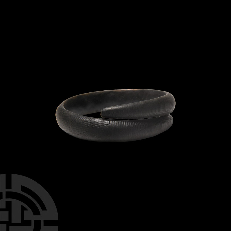 Bronze Age Decorated Bracelet. 2nd millennium B.C. A coiled bracelet composed of...