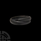 Bronze Age Decorated Bracelet. 2nd millennium B.C. A coiled bracelet composed of a D-section hoop and tapering terminals, the outer face engraved with...