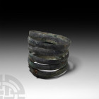 Bronze Age Spiral Bracelet. 2nd millennium B.C. A bronze bracelet formed as a coiled D-section penannular bar with rounded finials. 100 grams, 75 mm (...