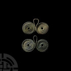 Bronze Age Coiled Spectacle Pendant Group. 16th-10th century B.C. A pair of spectacle pendants, each composed of two coiled wire circles with central ...