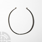 Bronze Age Neck Torc with Coiled Terminals. 8th-6th century B.C. A slender neck torc with round-section body, decoratively twisted central section, lo...