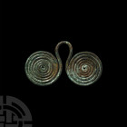 Bronze Age Spectacle Pendant. 7th-6th century B.C. A bronze Halstadt type C spectacle pendant composed of two coiled wire discs joined by a loop. 21 g...