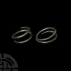 Bronze Age Child's Coiled Bracelet Pair. 13th-7th century B.C. A pair of two bronze bracelets, each composed of coiled round-section bodies and taperi...