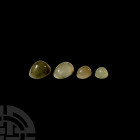 Polished Prehnite Cabochon Gemstone Group. A group of four polished plano-convex prehnite gemstone cabochons. 13.1 grams total, 11-20 mm (1/2 - 3/4 in...