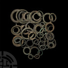 Iron Age Celtic Ring Money Collection. Late 1st millennium B.C. A group of over fifty ring money pieces from Northern Europe. 453 grams total, 15.7-48...