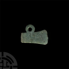 Iron Age Celtic or Roman Votive Axehead Pendant. c.8th century B.C.-early 5th century A.D. A flat-section votive axehead pendant with integral suspens...