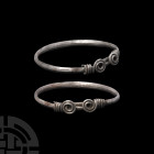 Iron Age Celtic Silver Coiled Bracelet. 1st century B.C.- 2nd century A.D. A silver annular bracelet composed of a carinated body and ornamental bezel...