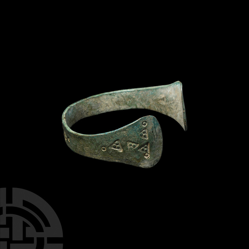 Viking Age Stamp-Decorated Bracelet. 9th-11th century A.D. A penannular bronze b...