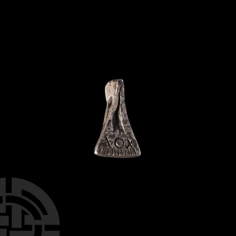 Viking Age Silver Axe Pendant. 9th-12th century A.D. A bifacial silver axe-shape...