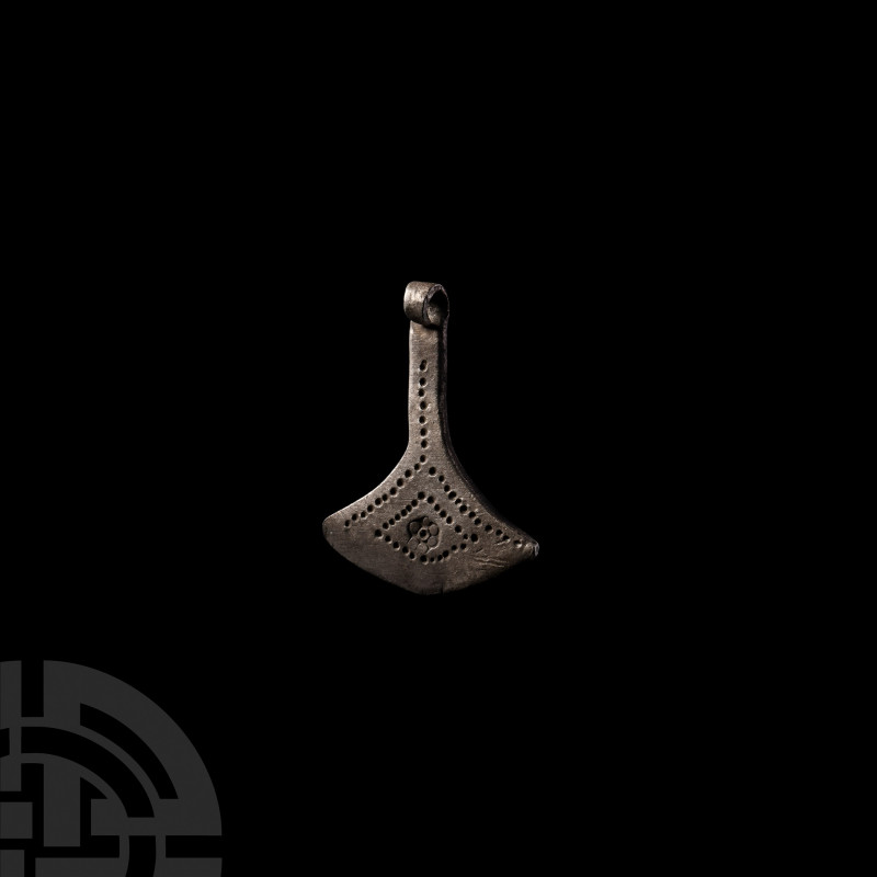 Viking Age Silver Axe Pendant. 9th-12th century A.D. A silver axe-shaped pendant...