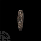 Anglo-Saxon Zoomorphic Strap End. 8th-9th century A.D. A silver zoomorphic strap end with panel of interlace design and beast head finial with large e...