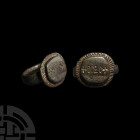 Medieval Ring with 'DEO'. 14th-15th century A.D. A bronze finger ring with ellipsoid bezel, undulating flange to the rim, intaglio with Latin inscript...
