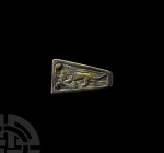 Medieval Gilt Lion Dagger Chape. 13th century A.D. A folded flat-section trapezoidal silver-gilt chape with raised border and image of the lion of Eng...