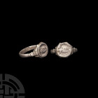 Medieval Silver Ring with Boars. 15th century A.D. A silver ring composed of a D-section hoop, notched shoulders and bezel bearing engraved boars. Cf....