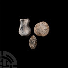Medieval Lead Artefact Collection. 13th-15th century A.D. A group of three lead artefacts comprising: a vesica-shaped seal with ear of corn at centre ...