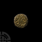 Medieval Gilt Strap Junction with Crowned Rider. 13th-15th century A.D. A discoid strap junction with gilt motif of a crowned rider. 12.7 grams, 26 mm...