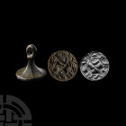 Medieval 'I am Private' Seal Matrix. 14th century A.D. A seal matrix with facetted shank and pierced handle, die bearing clasped hands fede motif, 'PR...