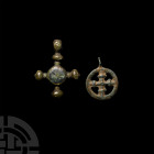 Medieval Cross Pendant Group. 12th-14th century A.D. A pair of pendants comprising: one cross within a circle, suspension loop (with small break) abov...