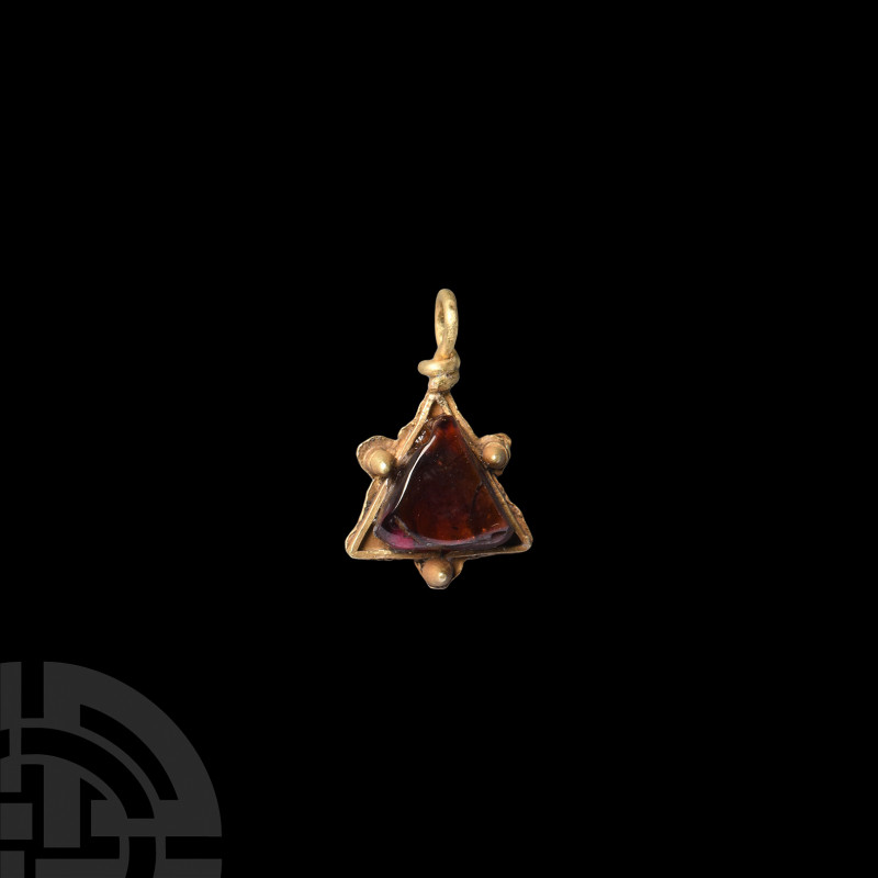 Medieval Gold and Garnet Pendant. 15th-16th century A.D. A gold pendant with a t...