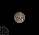 Medieval Silver Bracteate with Seated Figure. 11th century A.D. A German silver repoussé plaque with an enthroned figure holding cross-on-globe and a ...