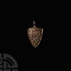 Medieval Heraldic Horse Harness Pendant with Three Lions. 13th-14th century A.D. A shield-shaped horse harness pendant bearing three graduated lions p...