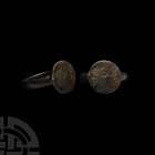 Medieval Decorated Ring. 15th-16th century A.D. A medieval or early post-medieval ring with D-section hoop supporting a discoid bezel displaying a sha...