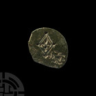 Medieval Test Strike Piece. 14th century A.D. An unusual bronze test strike piece with two distinct stamped motifs to one face: a fleur within a lozen...