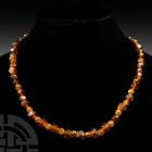 Glass Bead Necklace. 19th century A.D. or earlier. A restrung necklace composed of amber-coloured glass beads of various types; modern clasp. 38.8 gra...