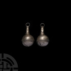 Silver Bell Pair. 19th century A.D. or earlier. A pair of silver crotal bells, each a bulbous body decorated with a medial band of applied ropework, s...