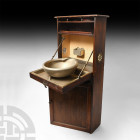 First World War Maritime Officer's Wash Cabinet. Early 20th century A.D. A mahogany and brass-fitted upright ship's washstand from a sea officer's cab...