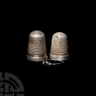 Victorian Silver Thimble and Ring Group. 19th century A.D. A group of three silver objects comprising two thimbles, one with geometric motifs around t...