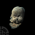 Blue Glass Cherub. 19th-20th century A.D. A glass cherub face with the appearance of a young child; remains of a collar below displaying a cutlass and...