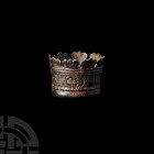 Crowned Ferrule with Faces. c.17th century A.D. A ferrule formed as a crown, simple detailing and stylised faces incised around the exterior. 11.2 gra...