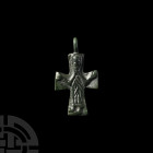 Post Byzantine Cross Pendant. 18th century A.D. or earlier. A bronze cross with the image of crucified Jesus, wearing a long robe (tunica talaris); su...