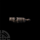 Whistle. 18th-19th century A.D. A lead-alloy whistle with crescentic sounding hole and mouthpiece, waisted knop pierced for suspension. 22.6 grams, 48...