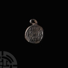 Lead Pendant Seal with Crowned E. 18th-19th century A.D. A discoid lead pendant seal with integral suspension loop and beaded border to both faces; on...