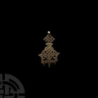 Dark Age Style Entwined Beasts Pendant. 19th-20th century A.D. A bifacial openwork entwined beasts pendant with hinged plaque composed of a cross with...