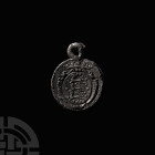 Lead Pendant Seal with Crowned Three Lions and Heraldic Device in a Heater-Shaped Shield. 18th-19th century A.D. A discoid lead seal pendant with inte...