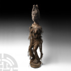Yoruba Standing Female Figure. 19th century A.D. A Yoruba Tribe standing female figure carved in wood, nude except for the remnant of a rough weave sk...
